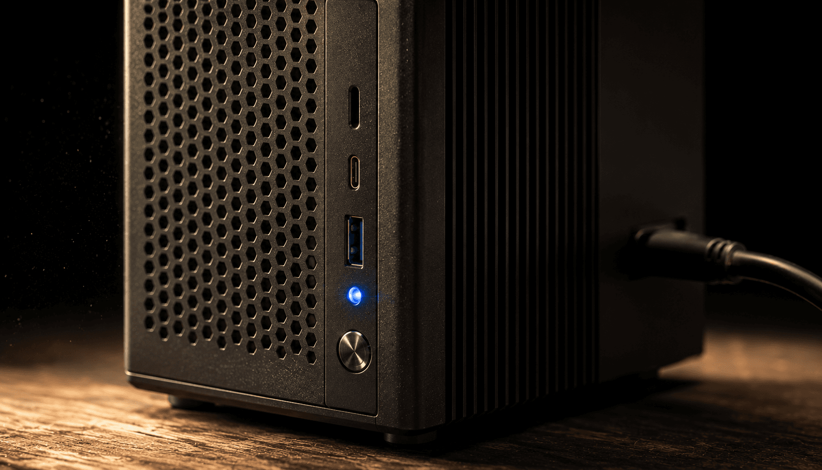 Macro detail of the workstation — matte black, blue power LED, USB-C ports